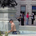 Man collecting coins in fountain, Old Montreal